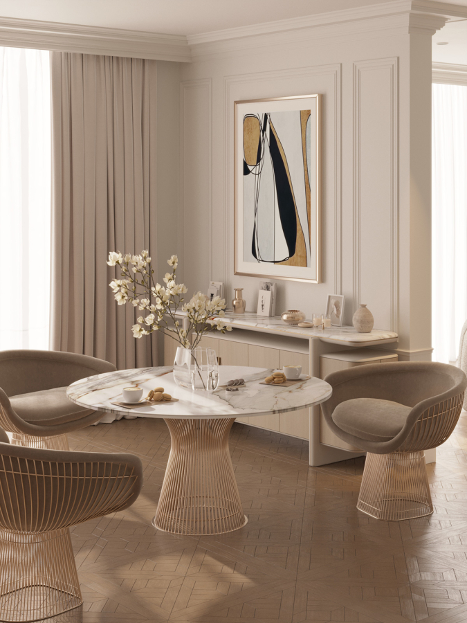 Elegant breakfast nook with round marble table, golden wire chairs, and abstract art — a peaceful corner bathed in soft daylight at Maison Révèle.