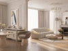 Elegant classic-modern living room with soft neutral tones, sculptural boucle sofas, and a marble fireplace reflecting natural morning light – Maison Révèle interior.