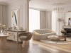 Refined classic-modern living room with blush-toned curved armchairs, marble fireplace, and elegant round mirror – soft daylight evokes timeless serenity – Maison Révèle interior.